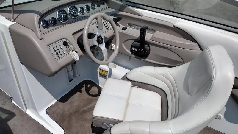 Slide: The Image of Captain's seat and steering wheel of a 1999 Cobalt 226 boat interior. - 16
