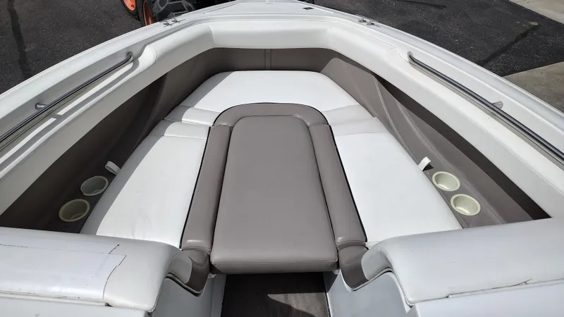 Slide: The Image of Interior of a 1999 Cobalt 226 boat featuring white and gray seating. - 19