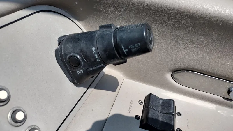 Slide: The Image of 1999 Cobalt 226 boat deck with storage compartments and seating area. - 27