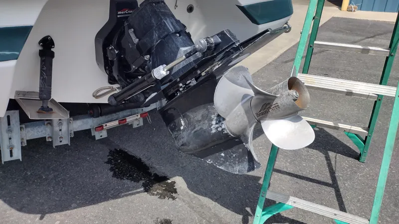 Slide: The Image of 1999 Cobalt 226 boat on trailer, parked near blue building. - 7