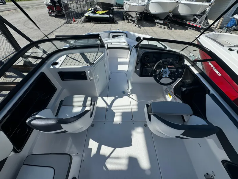 Slide: The Image of 2025 Yamaha Boats SX190 interior with dual seating and steering console. - 9