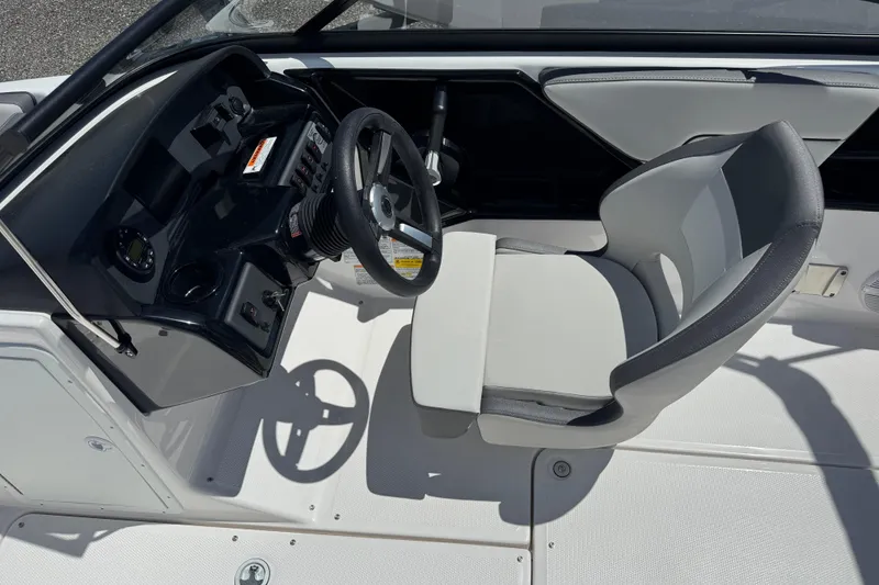 Slide: The Image of 2025 Yamaha Boats SX190 cockpit with steering wheel and captain's chair. - 15