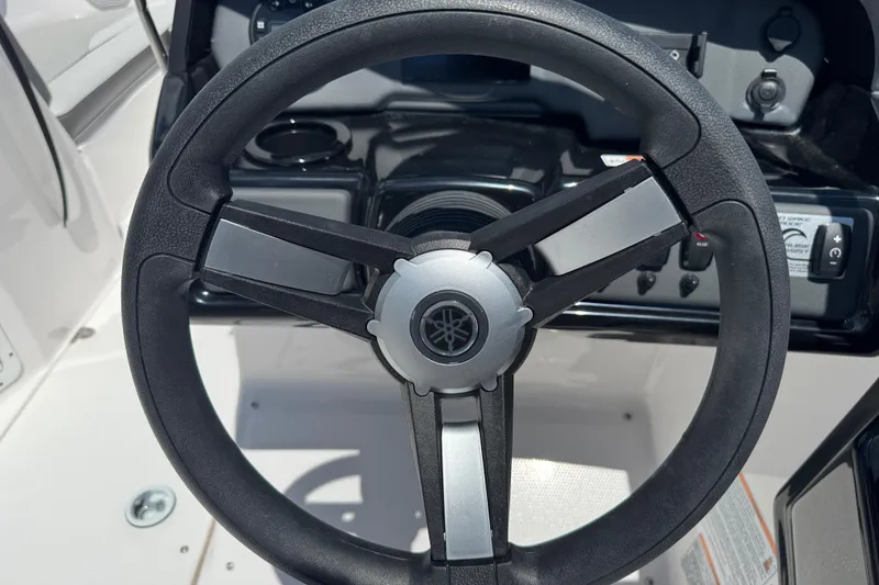 Slide: The Image of Steering wheel of 2025 Yamaha Boats SX190, showcasing sleek design and controls. - 19