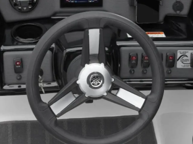 Slide: The Image of Steering wheel of 2025 Yamaha Boats SX190, featuring control panel and switches. - 27