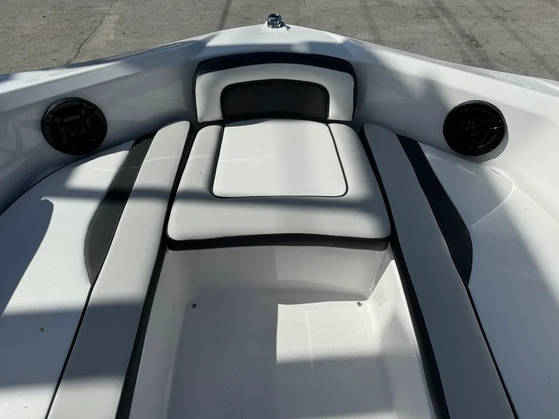Slide: The Image of 2025 Yamaha Boats SX190 interior with white cushioned seating and black accents. - 34
