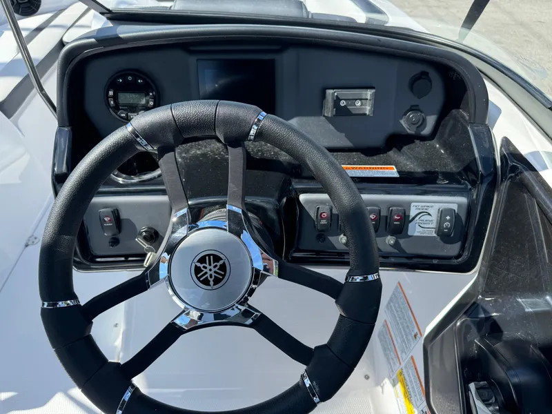 Slide: The Image of Steering wheel and dashboard of 2025 Yamaha Boats SX190, featuring modern controls and design. - 42