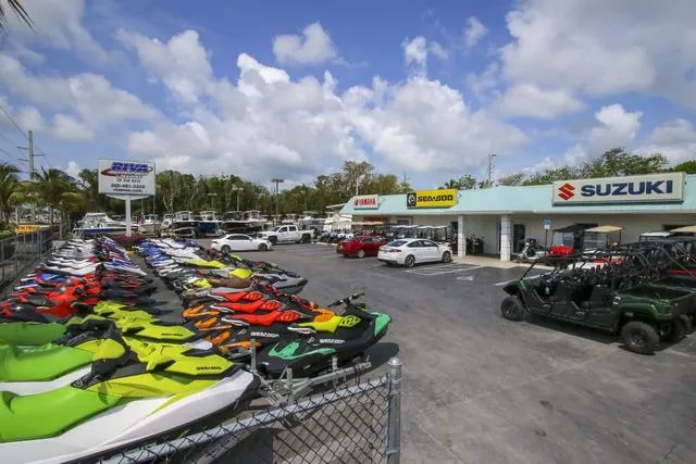 Slide: The Image of Outdoor display of colorful jet skis and off-road vehicles at a Yamaha dealership. - 44