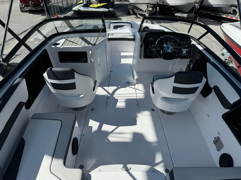 Slide: The Image of 2025 Yamaha Boats SX190 interior with sleek seating and modern dashboard design. - 8