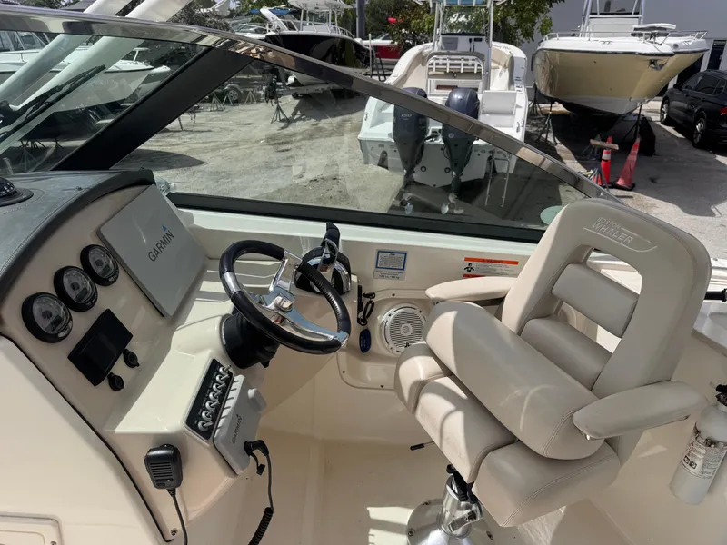 Slide: The Image of 2014 Boston Whaler 270 Vantage boat cockpit with steering wheel and control panel. - 10