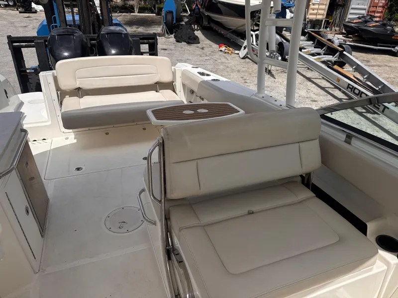 Slide: The Image of 2014 Boston Whaler 270 Vantage boat interior with beige seating and table. - 19
