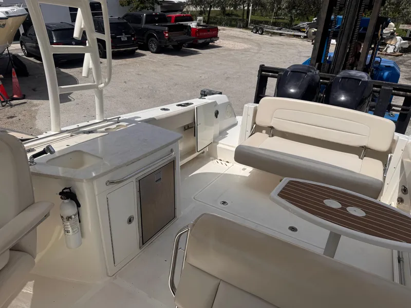 Slide: The Image of 2014 Boston Whaler 270 Vantage interior with seating, sink, and table. - 20