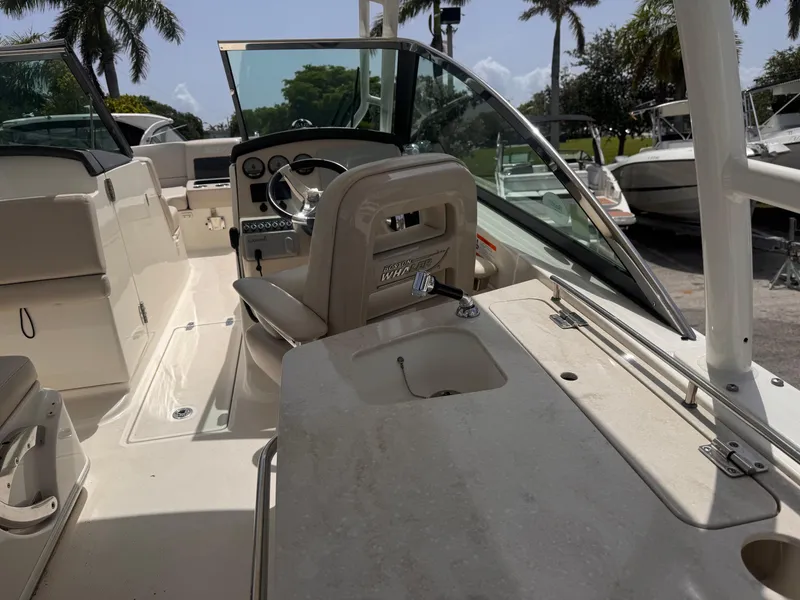 Slide: The Image of 2014 Boston Whaler 270 Vantage boat interior with seating and steering console. - 7