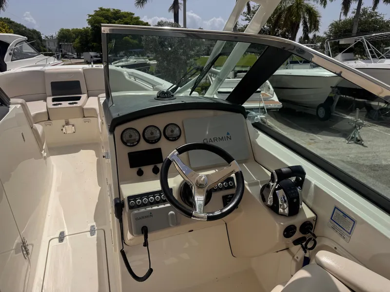 Slide: The Image of 2014 Boston Whaler 270 Vantage boat cockpit with Garmin navigation system and steering wheel. - 9