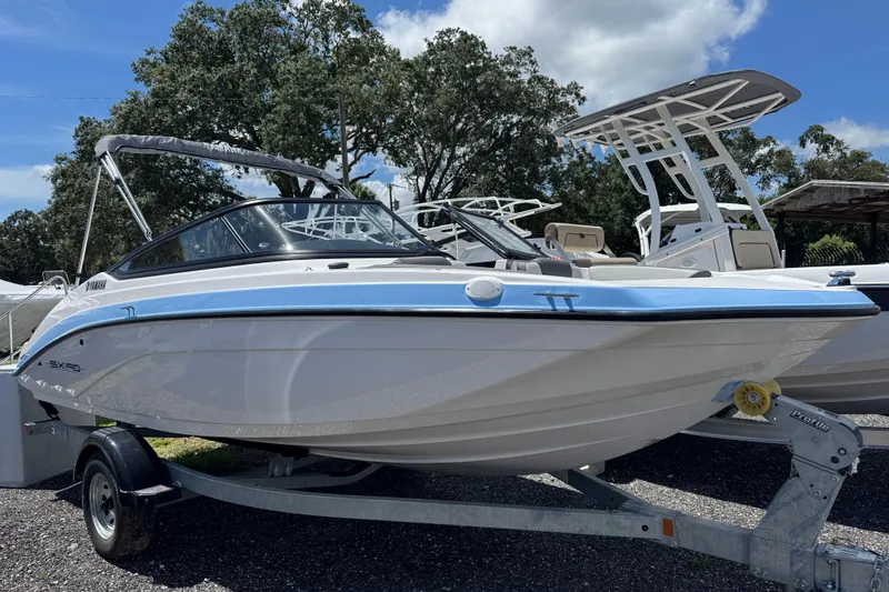 The Image of 2025 Yamaha Boats SX190 on trailer, sleek design under clear sky. - 0