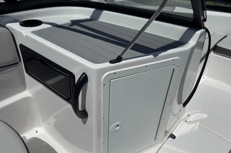 Slide: The Image of 2025 Yamaha Boats SX190 interior detail with storage compartment and cup holder. - 10