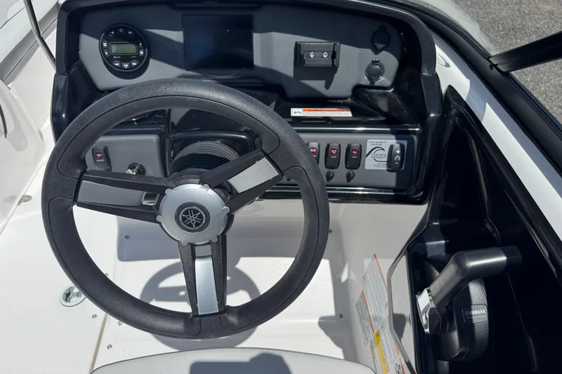 Slide: The Image of 2025 Yamaha Boats SX190 steering wheel and dashboard controls. - 16