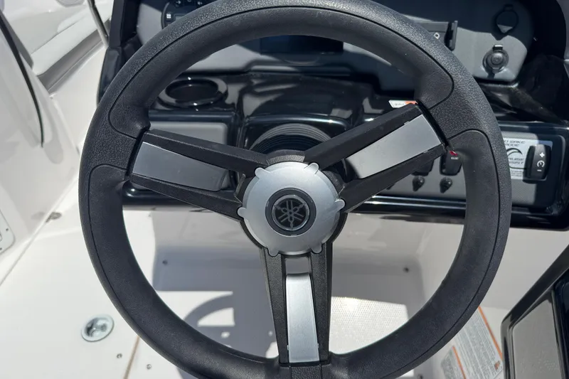 Slide: The Image of Steering wheel of 2025 Yamaha Boats SX190, showcasing sleek design and controls. - 19