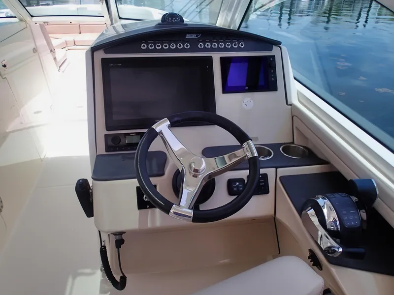 Slide: The Image of 2017 Boston Whaler 320 Vantage helm with modern controls and navigation system. - 13