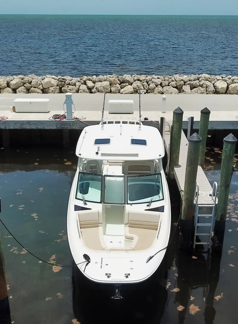 Slide: The Image of 2017 Boston Whaler 320 Vantage docked by the sea with clear skies. - 14
