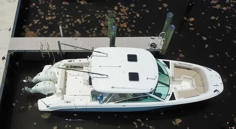 Slide: The Image of 2017 Boston Whaler 320 Vantage docked, aerial view, showcasing sleek design and dual engines. - 15