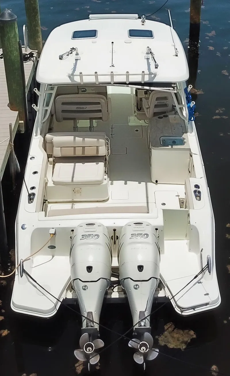 Slide: The Image of 2017 Boston Whaler 320 Vantage boat with dual engines, docked in a marina. - 2