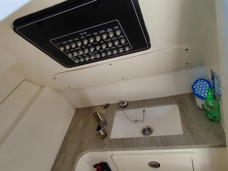 Slide: The Image of 2017 Boston Whaler 320 Vantage interior with sink and control panel. - 9