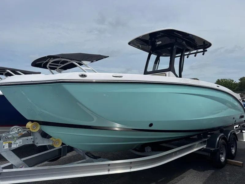 Slide: The Image of 2025 Yamaha Boats 255 FSH Sport H in light blue on trailer, side view. - 1