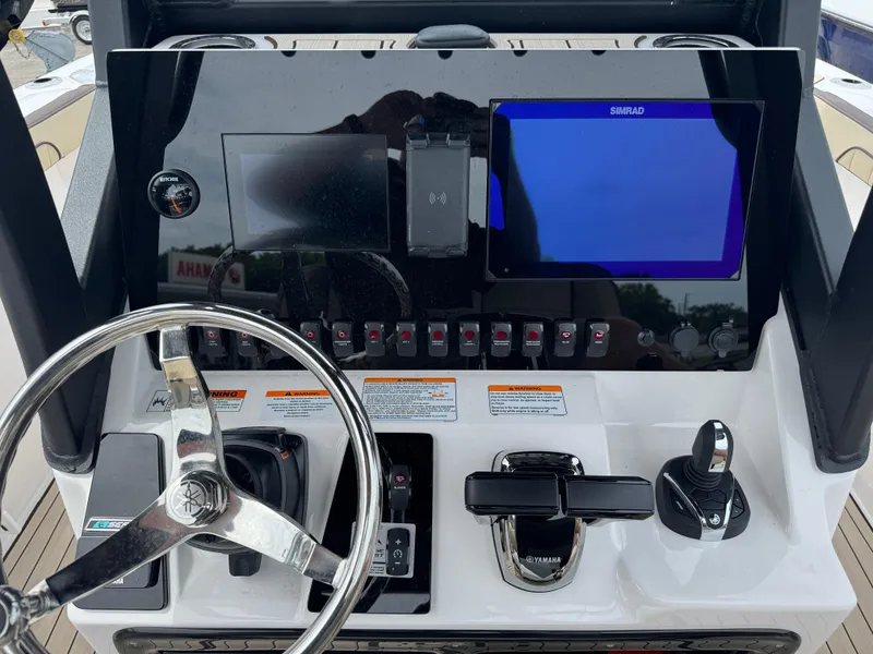 Slide: The Image of 2025 Yamaha Boats 255 FSH Sport H dashboard with steering wheel and control panel. - 5