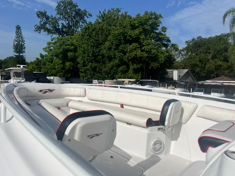 Slide: The Image of 2019 Glasstream 280 Pro-XS boat with white seating, docked near lush greenery. - 5