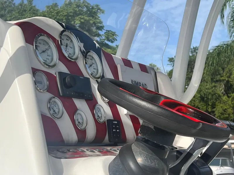 Slide: The Image of 2019 Glasstream 280 Pro-XS dashboard with American flag design and steering wheel. - 7