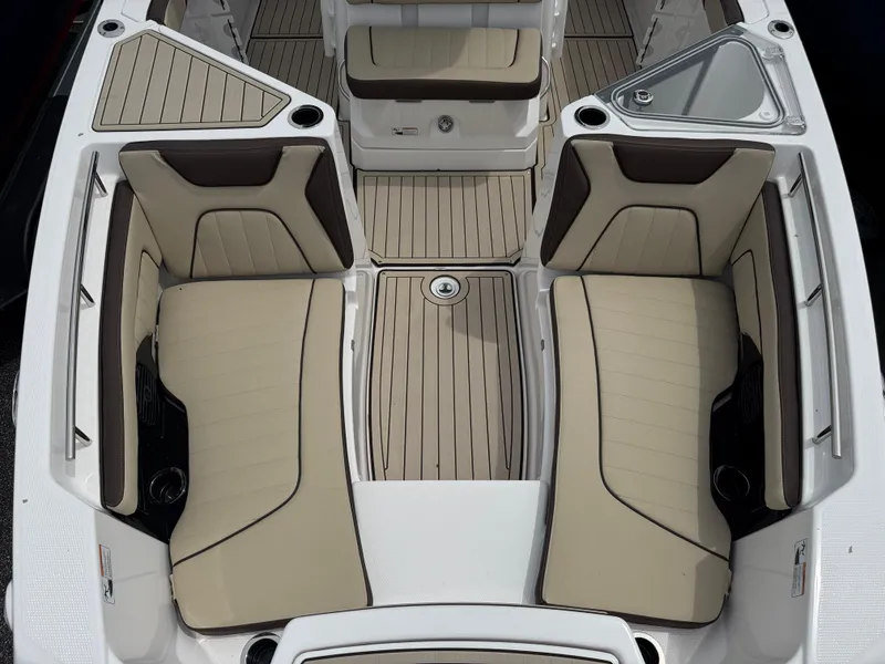 Slide: The Image of 2025 Yamaha Boats 255 FSH Sport H interior with beige seating and sleek design. - 11