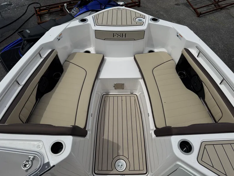 Slide: The Image of 2025 Yamaha Boats 255 FSH Sport H interior with beige seating and deck. - 8