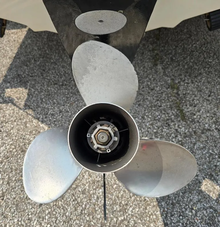 Slide: The Image of Propeller of 1994 Sea Ray 220 Overnighter boat on asphalt surface. - 15