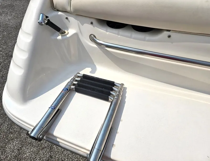 Slide: The Image of 1994 Sea Ray 220 Overnighter boat swim platform with retractable ladder and stainless steel rail. - 22