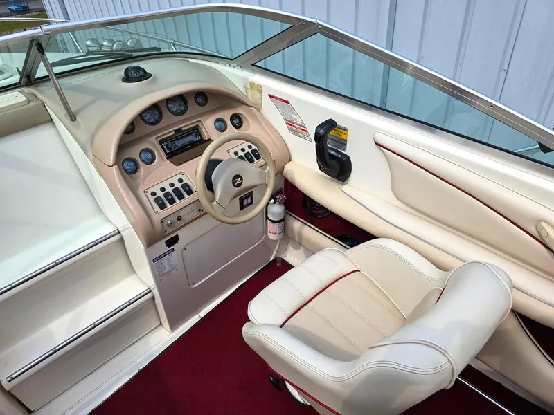 Slide: The Image of 1994 Sea Ray 220 Overnighter boat interior with steering wheel and control panel. - 3