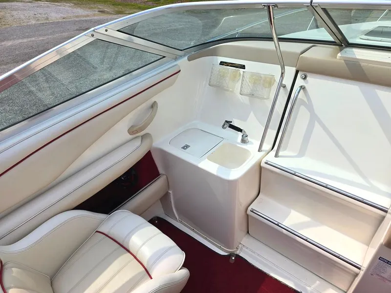 Slide: The Image of Interior of a 1994 Sea Ray 220 Overnighter boat with white seating and sink. - 4