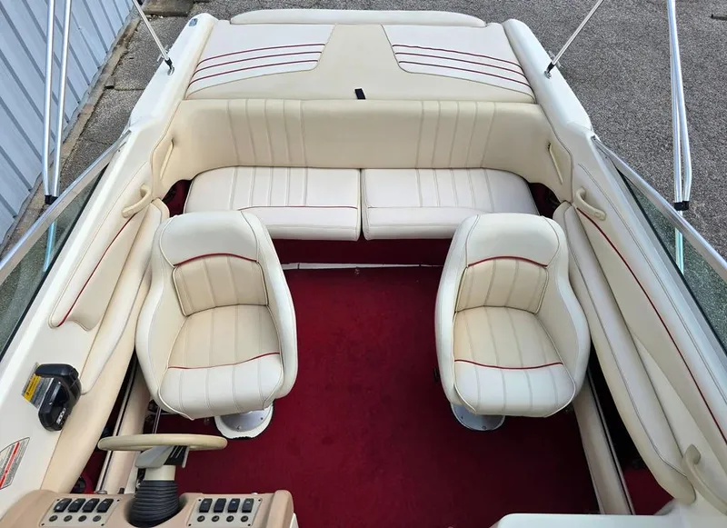 Slide: The Image of 1994 Sea Ray 220 Overnighter boat interior with cream seats and red carpet. - 5