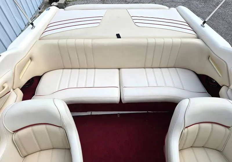 Slide: The Image of 1994 Sea Ray 220 Overnighter boat interior with white and red-trimmed seating. - 6
