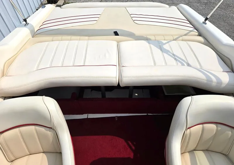 Slide: The Image of 1994 Sea Ray 220 Overnighter boat interior with cream leather seats and red accents. - 7