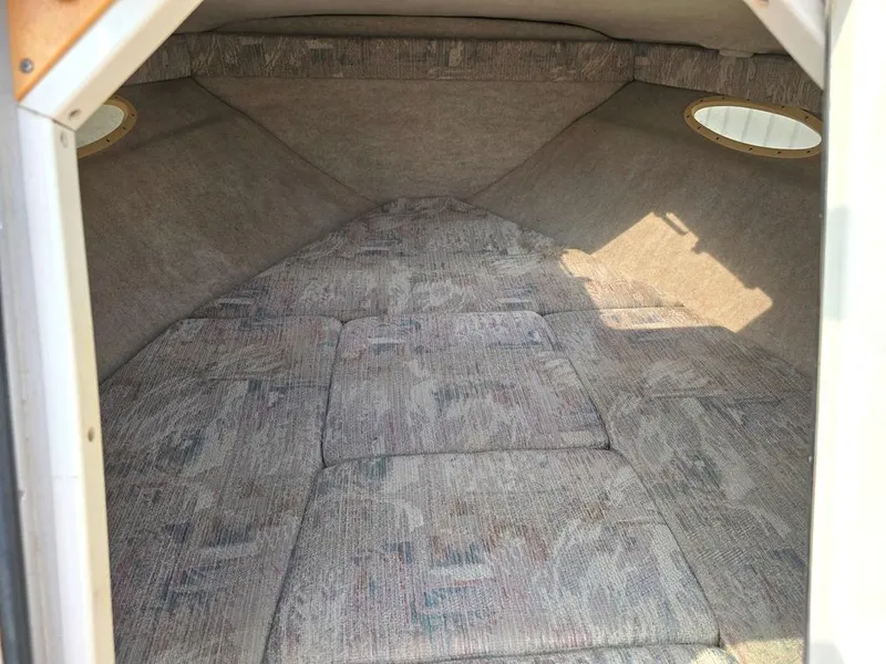 Slide: The Image of Interior cabin of 1994 Sea Ray 220 Overnighter boat with cushioned seating. - 8