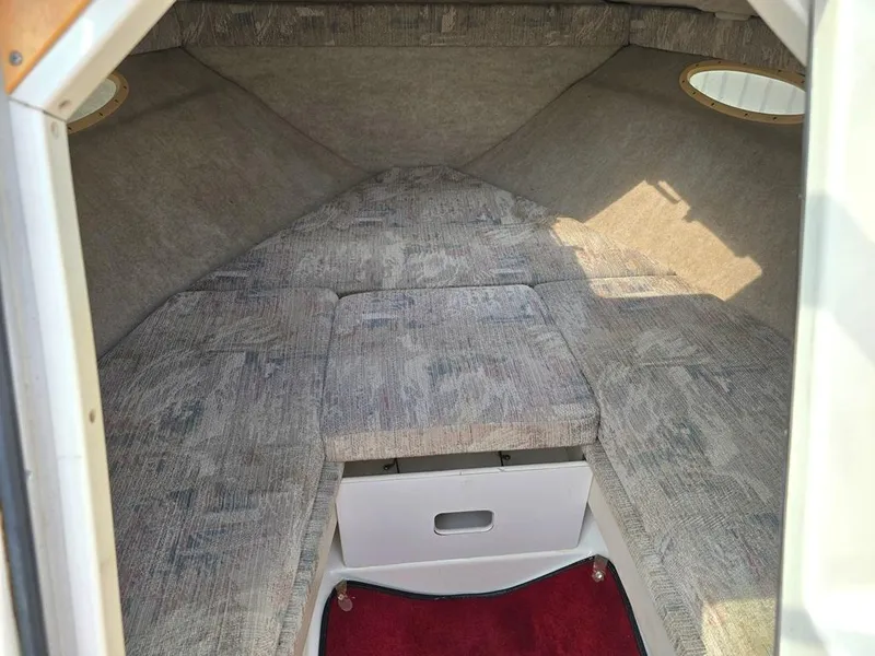 Slide: The Image of Interior cabin of 1994 Sea Ray 220 Overnighter boat with cushioned seating. - 9