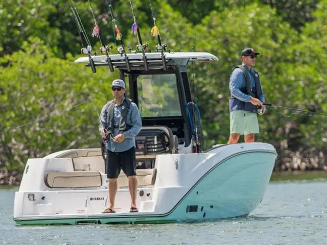Slide: The Image of Two people fishing on a 2025 Yamaha Boats 255 FSH Sport H in a scenic waterway. - 3