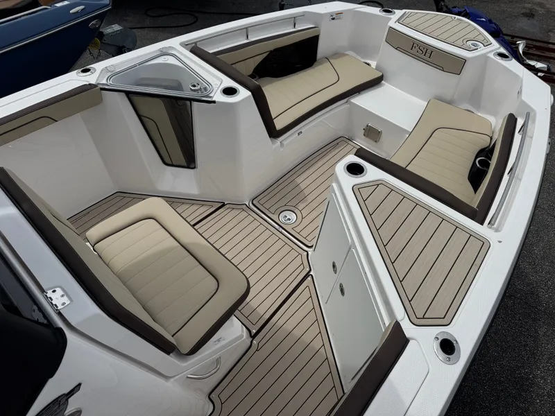 Slide: The Image of 2025 Yamaha Boats 255 FSH Sport H interior with cushioned seating and sleek design. - 6