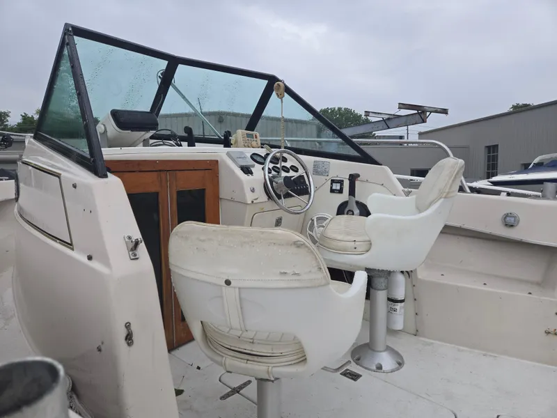 Slide: The Image of 1992 Dixie 21 boat interior with steering wheel and white seats. - 6