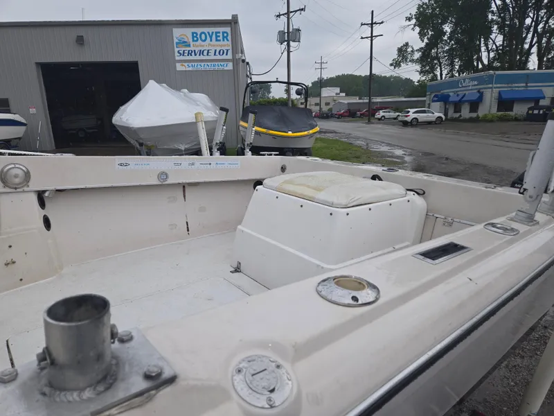 Slide: The Image of 1992 Dixie 21 boat at Boyer service lot, with overcast sky and nearby buildings. - 8