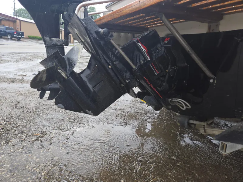 Slide: The Image of Close-up of a 1992 Dixie 21 boat motor and propeller on wet ground. - 9