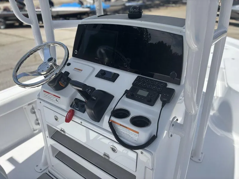 Slide: The Image of 2024 Sportsman Masters 227 Bay boat console with steering wheel and navigation controls. - 10