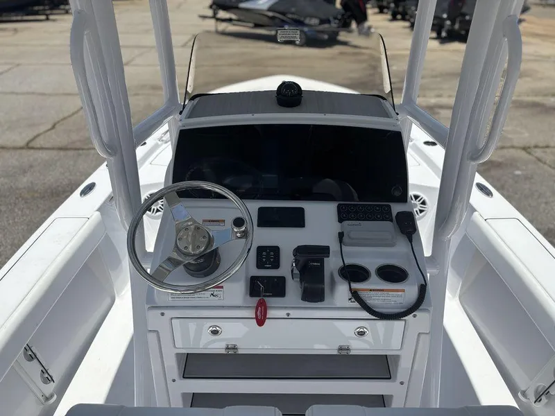 Slide: The Image of 2024 Sportsman Masters 227 Bay boat console with steering wheel and controls. - 11