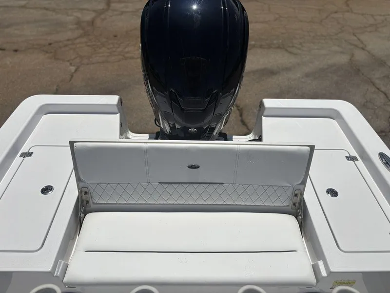 Slide: The Image of 2024 Sportsman Masters 227 Bay boat with white seating and engine view. - 21