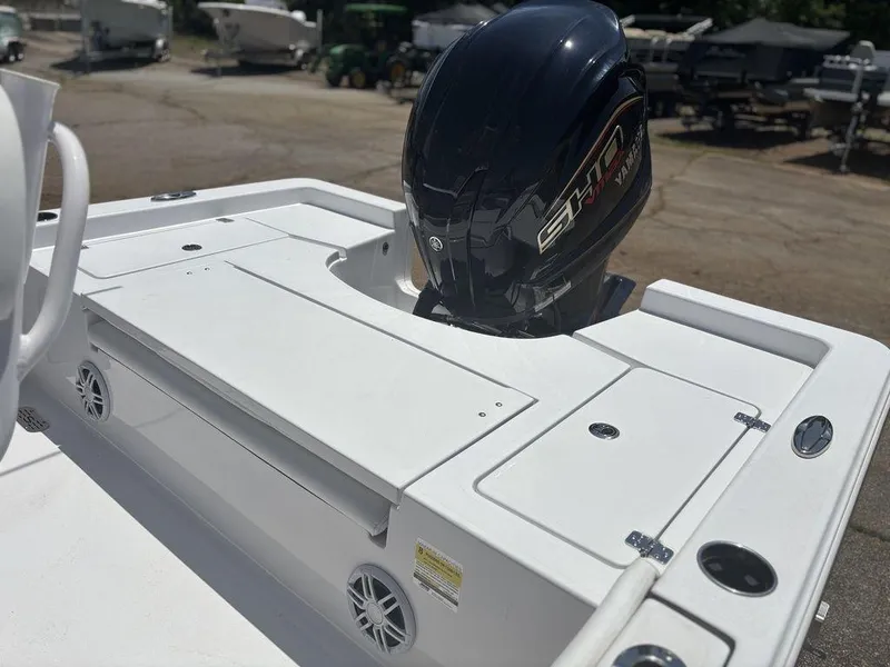 Slide: The Image of 2024 Sportsman Masters 227 Bay boat with outboard motor, featuring a sleek white deck design. - 22